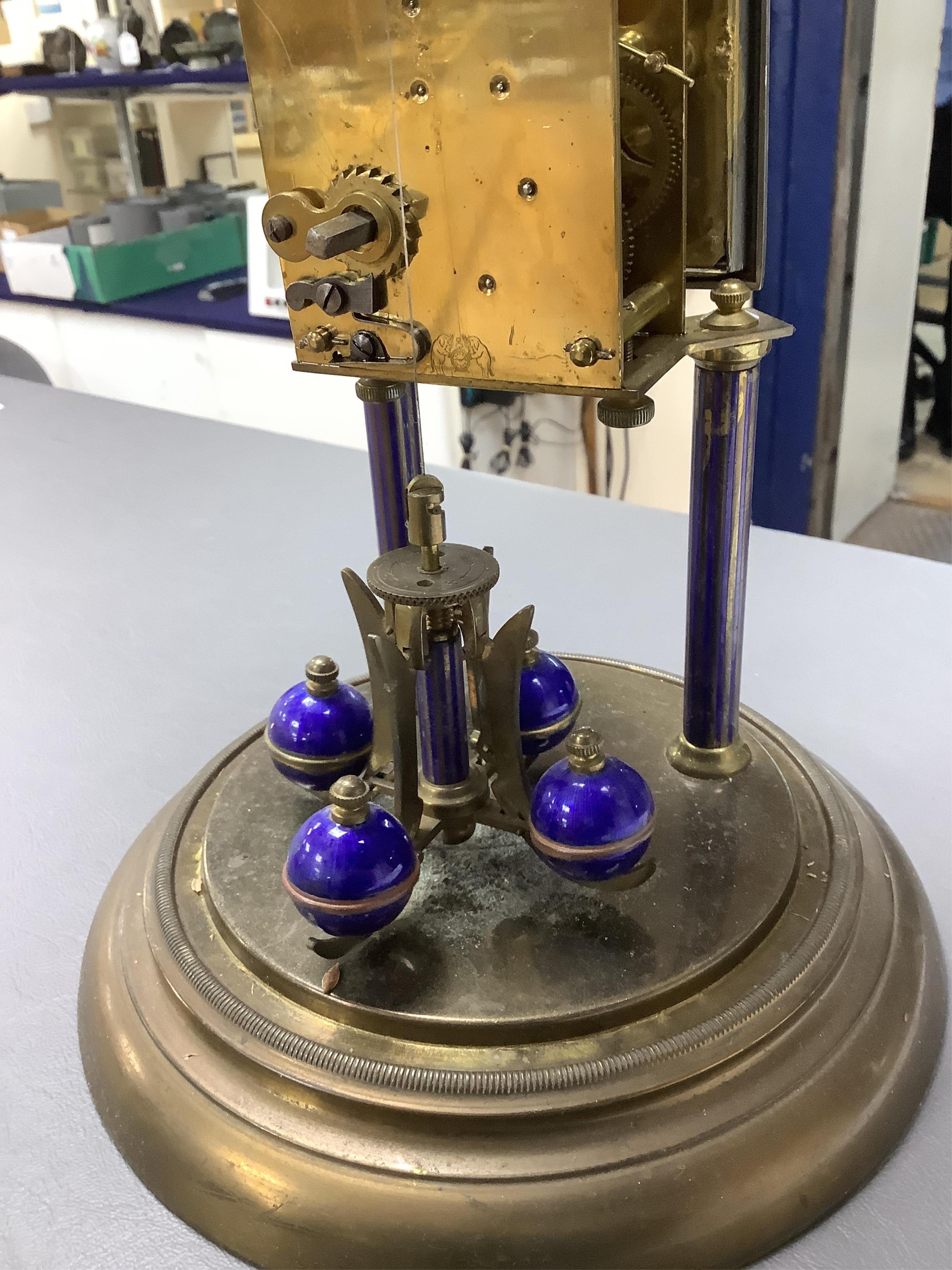 A Jahresuhrenfabrik anniversary clock with blue-enamelled dial, under glass dome, 32cm